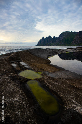 Mighty mountains rising from the sea. The landscape of the stunning Norwegian island of Senja photo