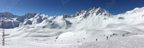 Panorama of snowy mountain peaks and ski slopes at Tignes, ski resort in the Alps, France