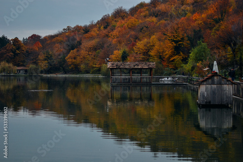 Luxury hotel in a nature park in autumn, Dense Smoke Rises From the Chimney. House by the lake in autumn, bike path near the lake, Recreation walk, and cycle path road sign. 