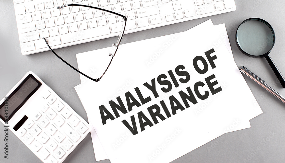 ANALYSIS OF VARIANCE text on paper with keyboard, calculator on grey background ANALYSIS OF VARIANCE text on paper with keyboard, calculator on grey background