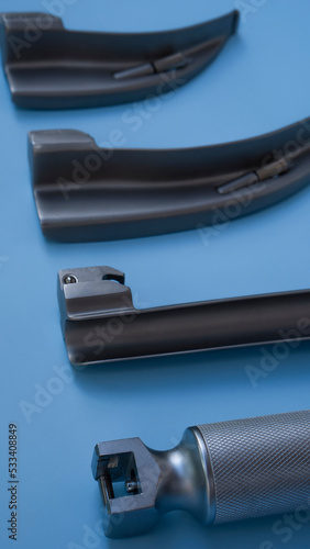 set for intubation of the trachea: blades for a laryngoscope of different sizes lie on a blue background close-up