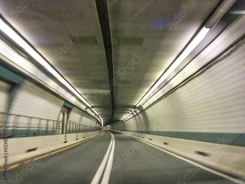 Driving along a long city tunnel