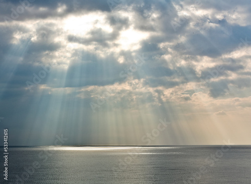 Sunshine shinning through the clouds onto the Mediterranean sea in Nice, France. 