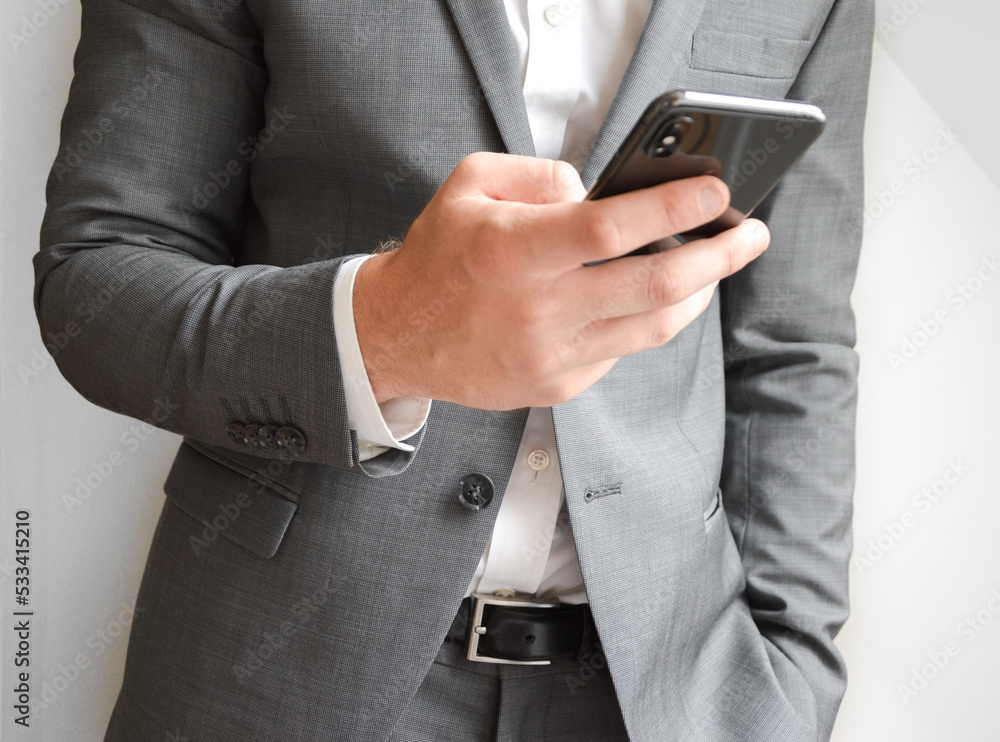 Midsection of businessman holding a mobile phone Midsection of businessman holding a mobile phone