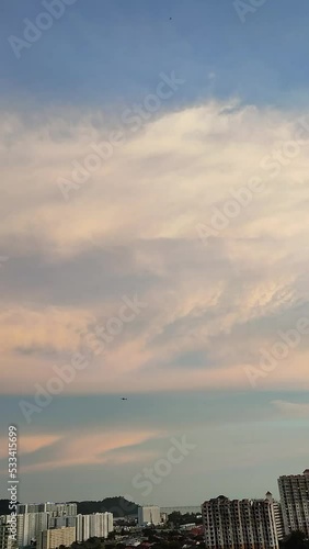 beautiful pink sunset, cityscape, skyscape, cloudscape, with a plane fly pass photo