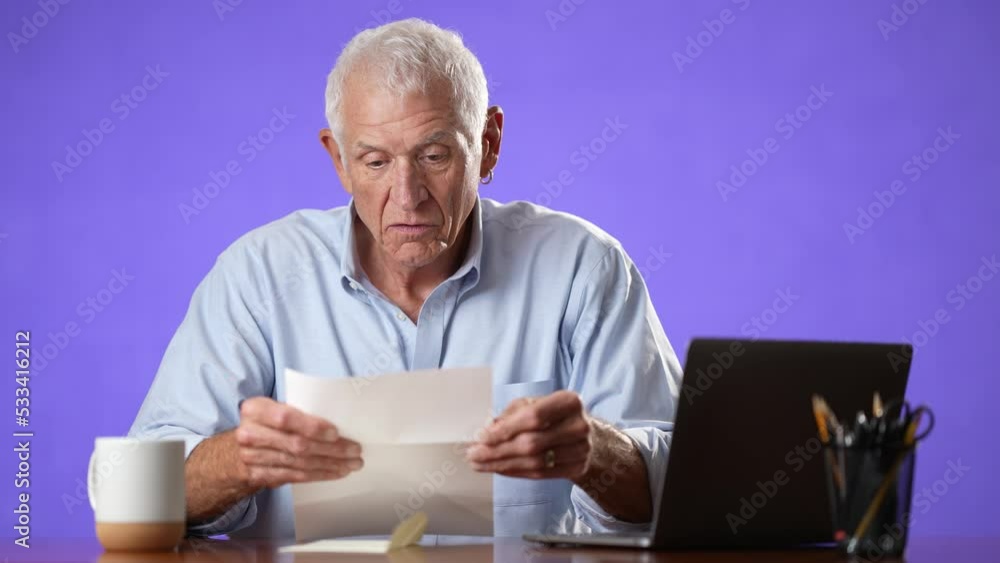 Portrait of happy excited male elderly man opening mail letter reading good news celebrating success, receiving loan approval, salary bonus, get promoted concept isolated on solid purple background Portrait of happy excited male elderly man opening mail letter reading good news celebrating success, receiving loan approval, salary bonus, get promoted concept isolated on solid purple background
