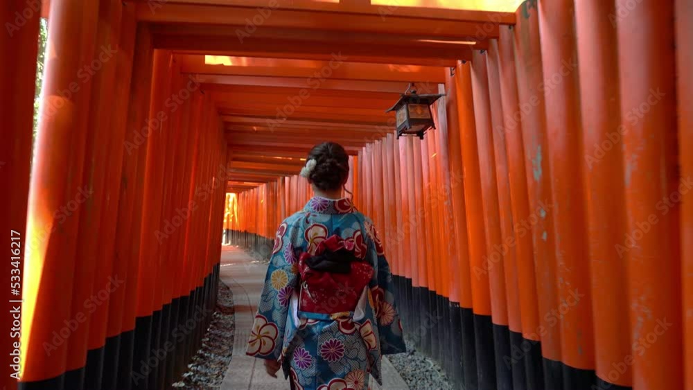 Asian women in traditional japanese kimonos visiting at Fushimi Inari