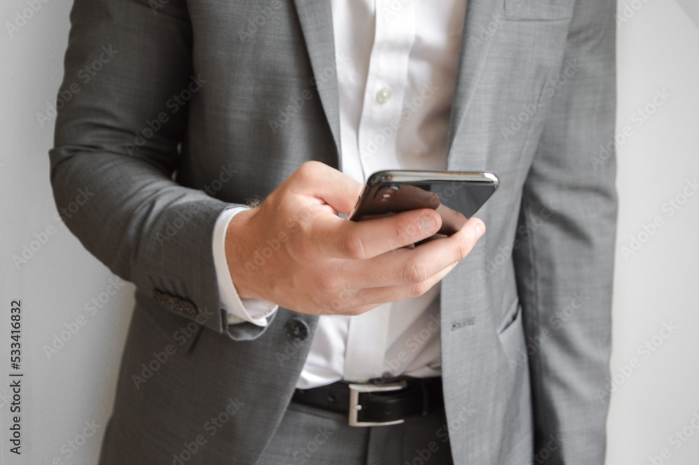 Midsection of businessman holding a mobile phone Midsection of businessman holding a mobile phone