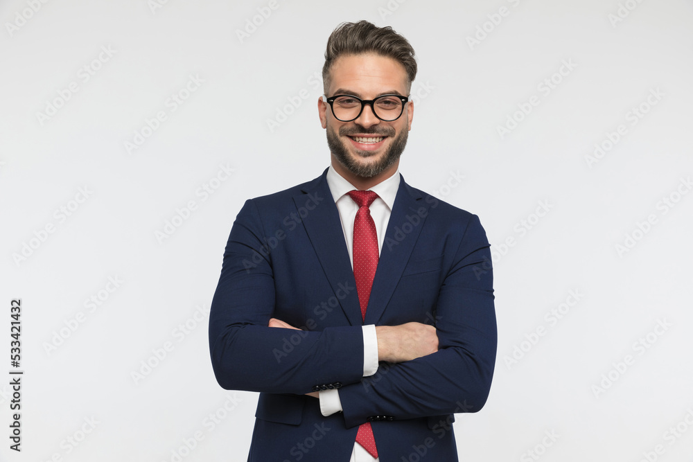 happy businessman with glasses crossing arms, smiling and posing happy businessman with glasses crossing arms, smiling and posing