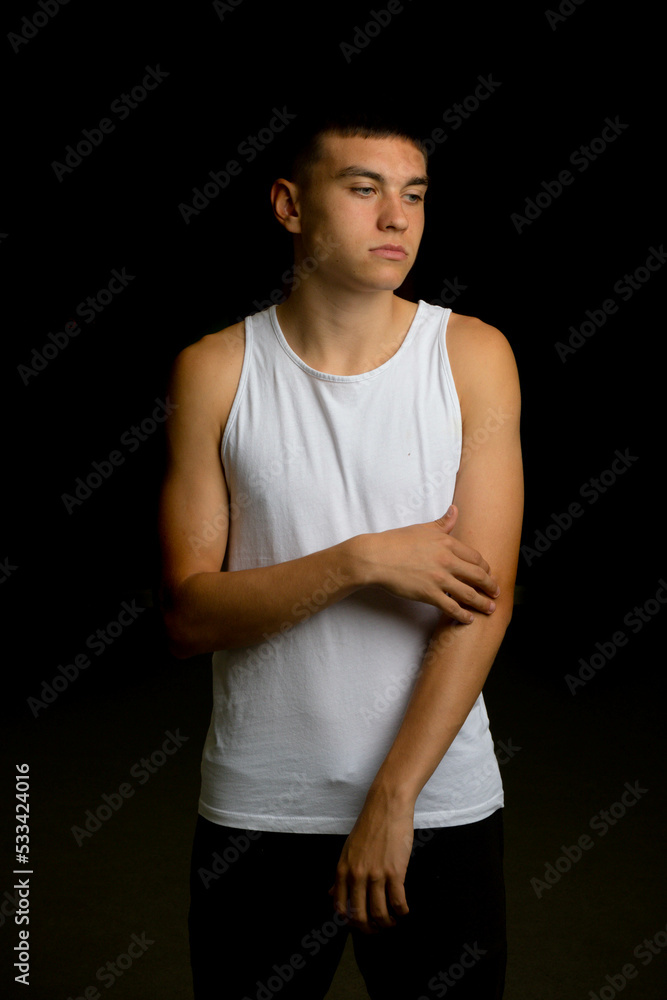 Nineteen year old teen boy flexing his arm muscles Nineteen year old teen boy flexing his arm muscles