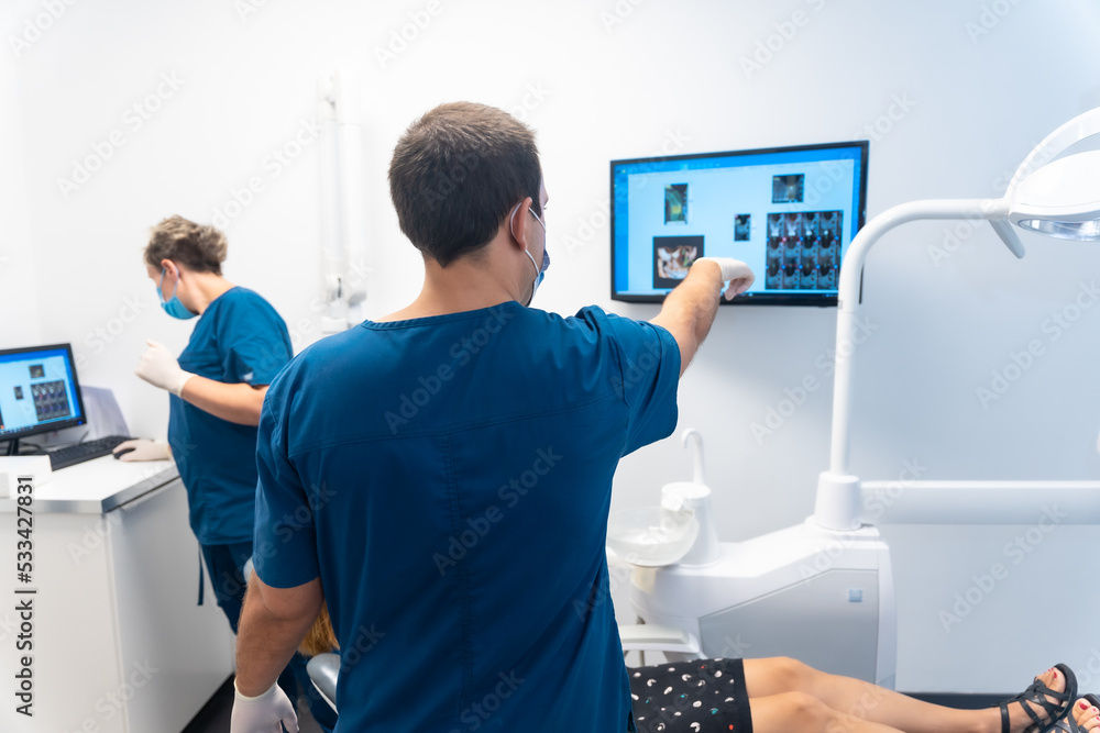 Dental clinic, routine annual medical check-up of a young woman, looking at the x-ray