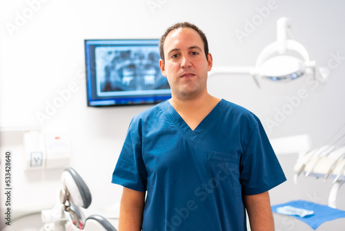 Dental clinic, portrait of a Caucasian male dentist at his workplace. clinic owner