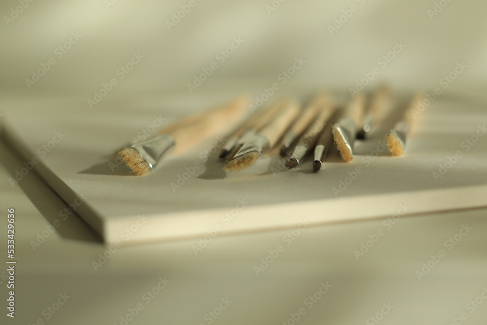 set of paint brushes and white paper set of paint brushes and white paper