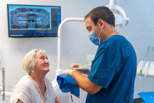 Dental clinic  dentist doctor explaining to elderly woman dental treatment  denture