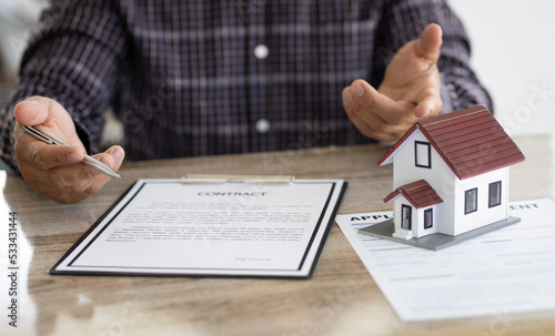 Real estate agents are discussing the terms of signing contracts, legal agreements, land purchases, mortgages and home rentals.
