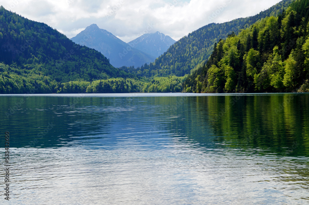 gorgeous emerald-green lake Alpsee in the German Alps in Hohenschwangau near castles Hohenschwangau and Neuschwanstein, Allgau, Bavaria, Germany