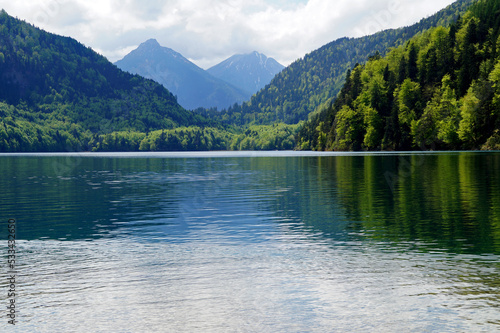 gorgeous emerald-green lake Alpsee in the German Alps in Hohenschwangau near castles Hohenschwangau and Neuschwanstein, Allgau, Bavaria, Germany © Julia