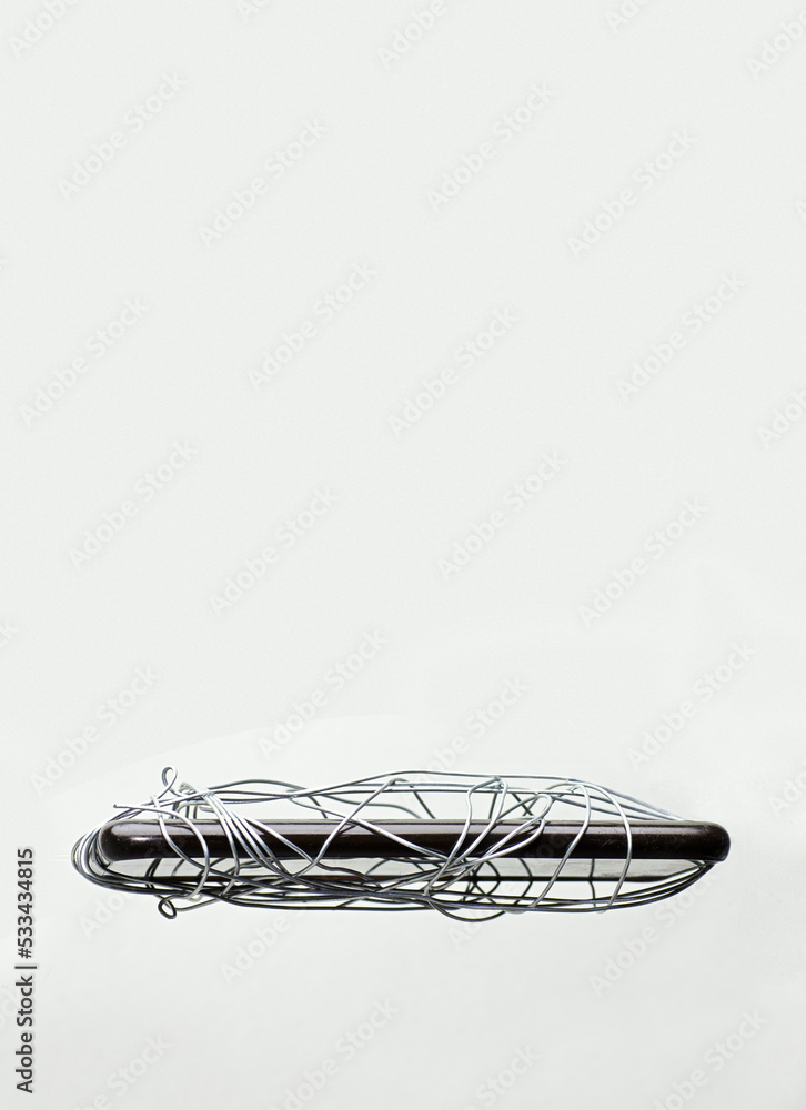tangled wire in smartphone, gray-green background, censorship of social networks. cancel cultural ban, erase tangled wire in smartphone, gray-green background, censorship of social networks. cancel cultural ban, erase
