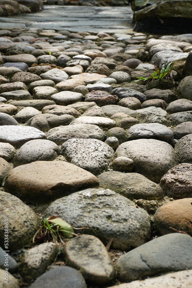 arrangement of stones and cement on the road in a public park arrangement of stones and cement on the road in a public park
