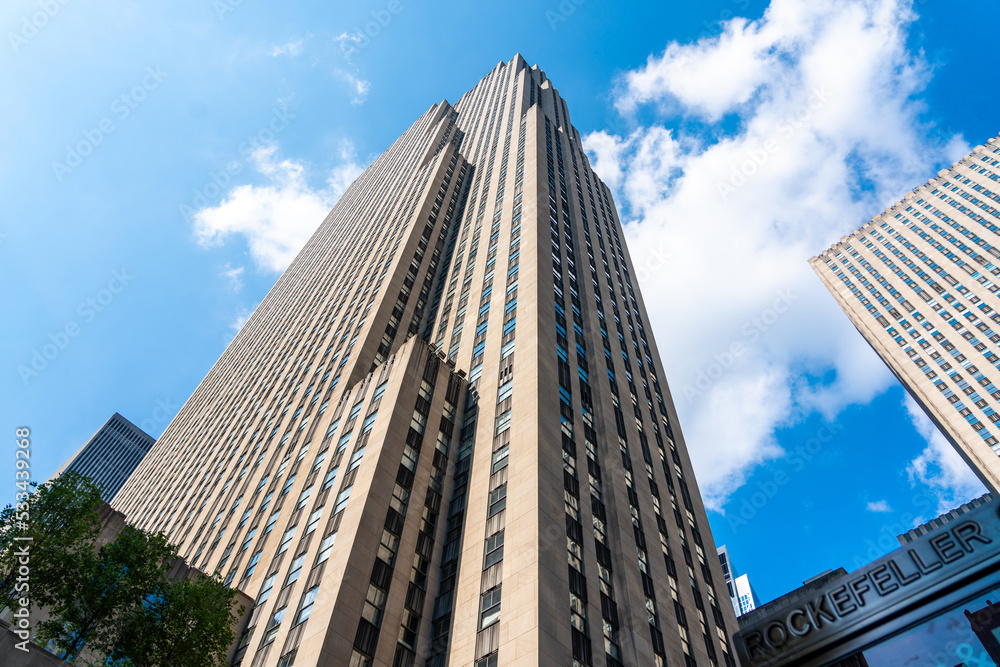 Rockefeller Center tower bottom view against blue sky in Manhattan in New York