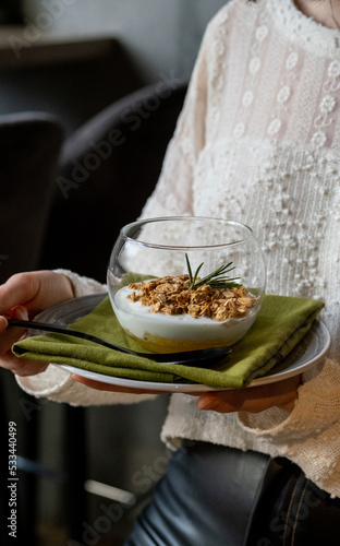 Granola glass plate. Serving granola with berries and fruits. Breakfast granola in a cafe