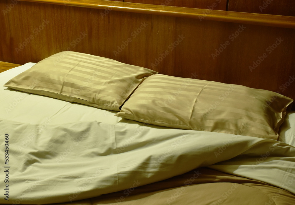 two pillow and blanket opened for one people on pair bed in night two pillow and blanket opened for one people on pair bed in night