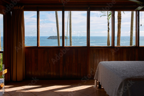 Views of the sea from inside the wooden bedroom through the windows
