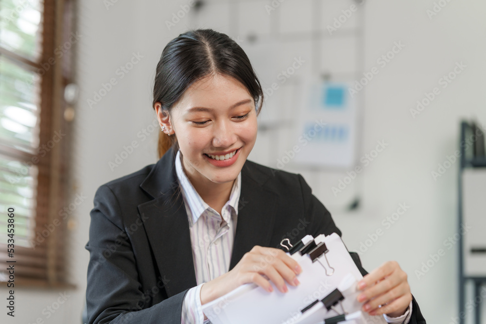 Happy attractive joyful asian woman working at workstation. Happy attractive joyful asian woman working at workstation.