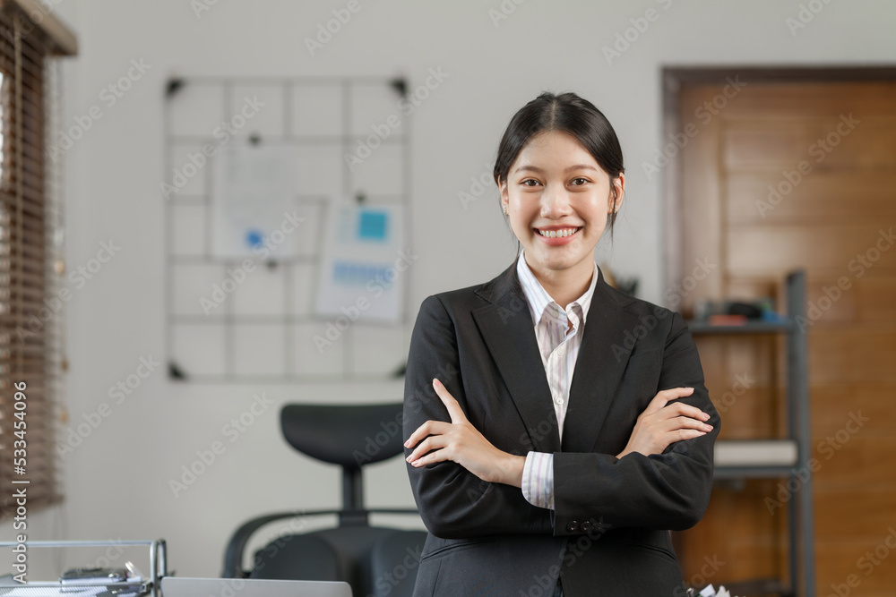 Happy attractive joyful asian woman working at workstation. Happy attractive joyful asian woman working at workstation.