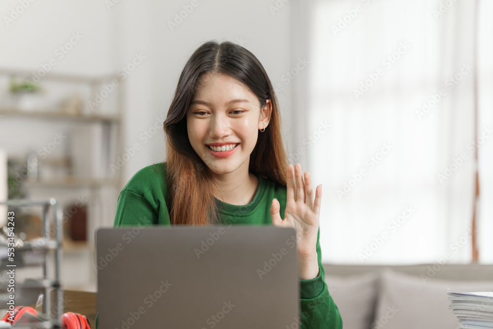Young cheery happy positive asian woman sit indoors and using laptop, relax time. Young cheery happy positive asian woman sit indoors and using laptop, relax time.