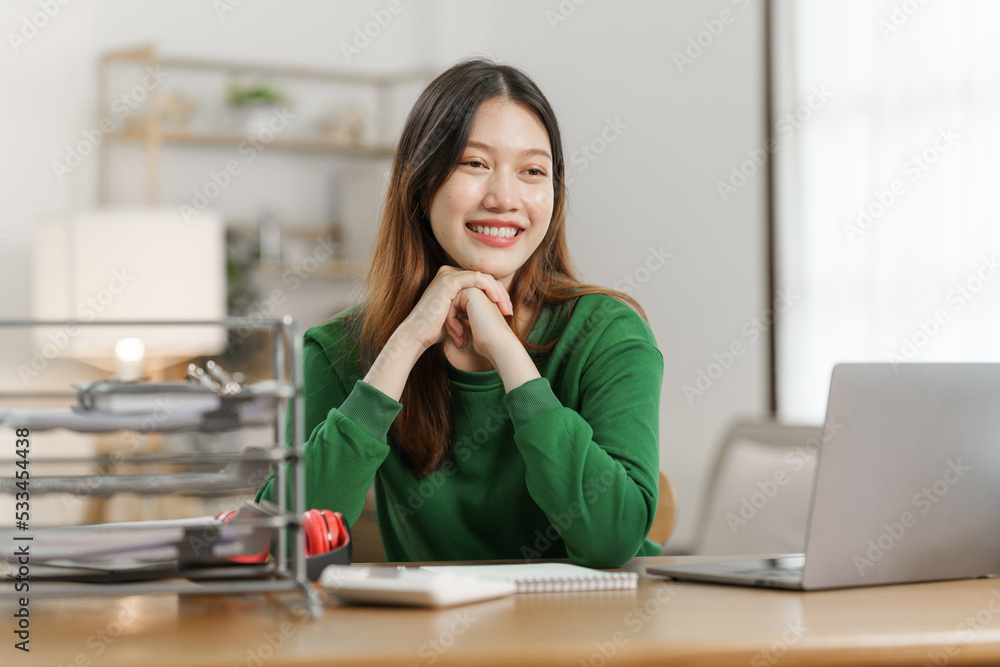 Young cheery happy positive asian woman sit indoors and using laptop, relax time. Young cheery happy positive asian woman sit indoors and using laptop, relax time.