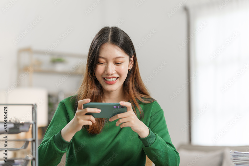 Happy young attractive smiling asian woman enjoying relax time at apartment. Happy young attractive smiling asian woman enjoying relax time at apartment.