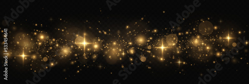 The dust sparks and golden stars shine with special light. Glitter bokeh lights isolated on a transparent background. Sparkling space magical dust particles.