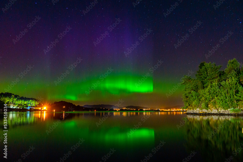 northern lights across the sea and mountains