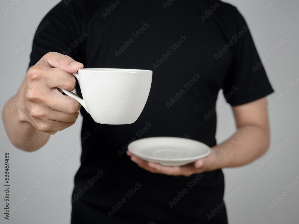 Close-up man hand holding coffee cup studio shot Close-up man hand holding coffee cup studio shot