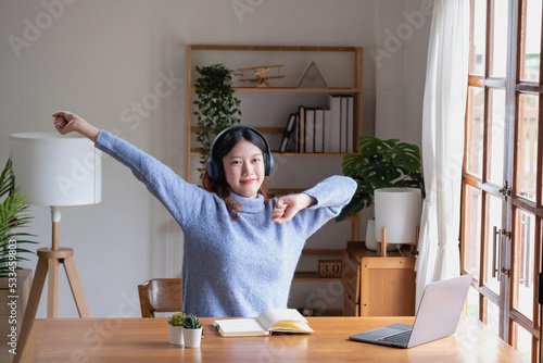 Relax, de-stress, vacation, have fun. Asian women take notes of their own past happily at home.