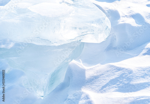 Ice hummocks on Baikal Lake. Transparent blue ice floe at sunset. Natural background.