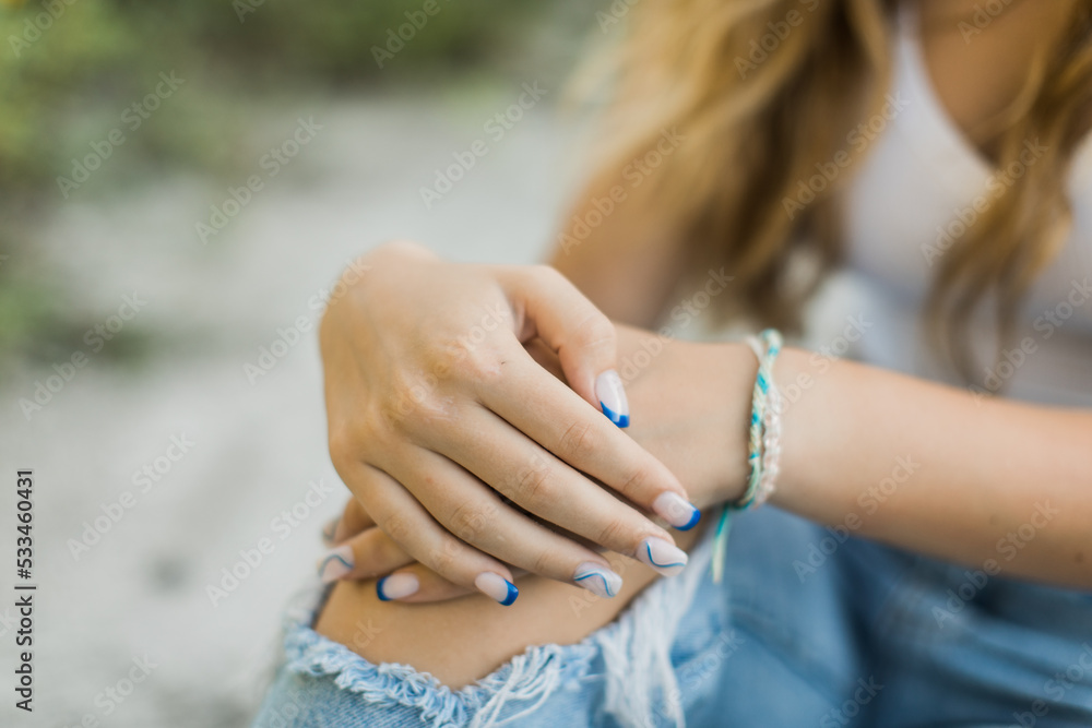 Hands with beautiful blue nails of a young lady