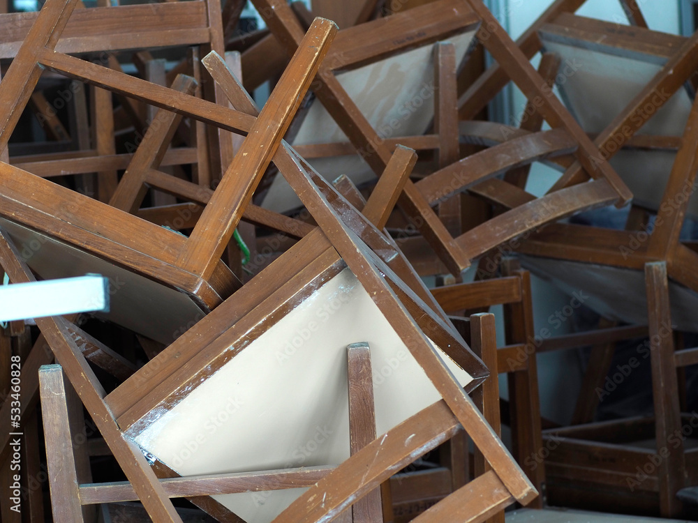 Recycling dump with trash of broken chairs, wooden chairs. pile of