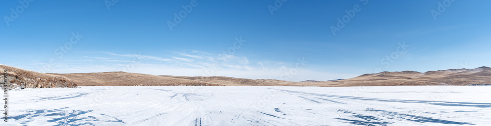 Winter landscape panorama with mountains and Lake Baikal in Siberia on sunny day. Natural background.