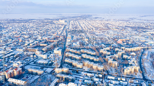 Above view on cityscape covered with snow, appearance of the city in winter.