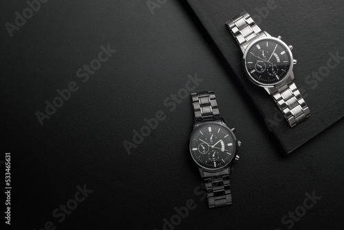Luxury white and black chrome watches on black background