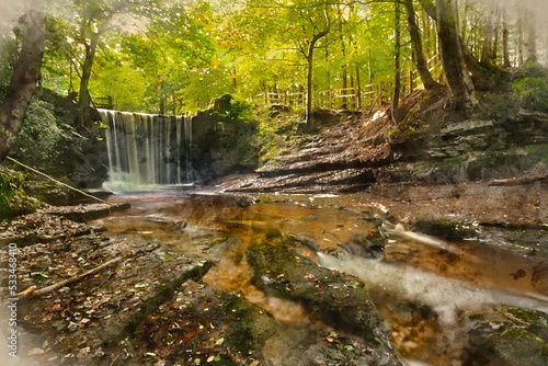 Epic beautiful Autumn landscape image of Nant Mill waterfall in Wales with glowing sunlight through the woodland