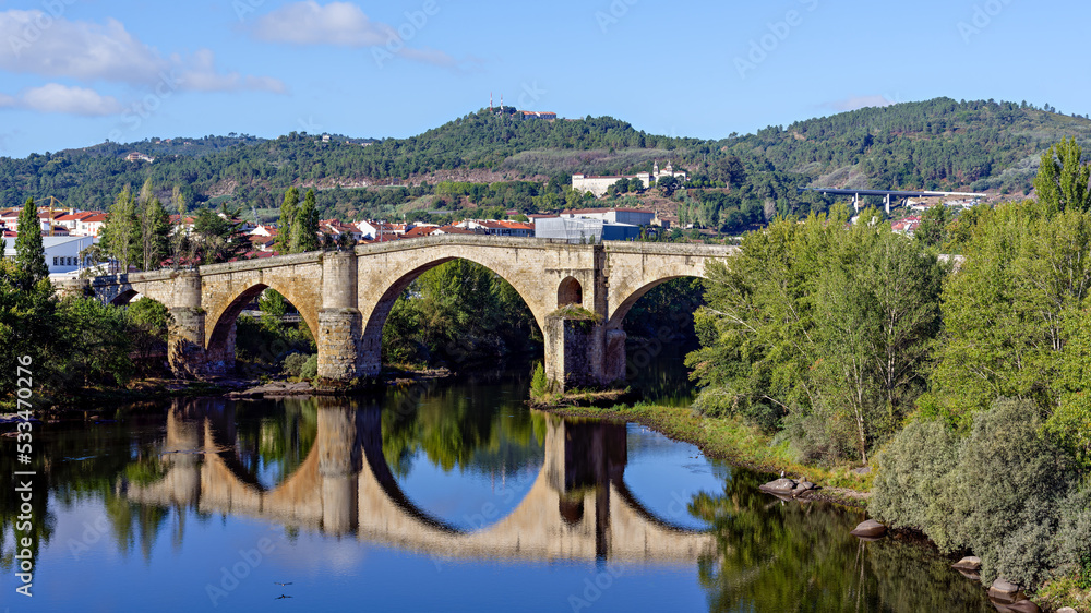 Panoramic view of historic Roman bridge, or Old bridge, over river Miño in the city of Ourense, Galicia, Spain.
