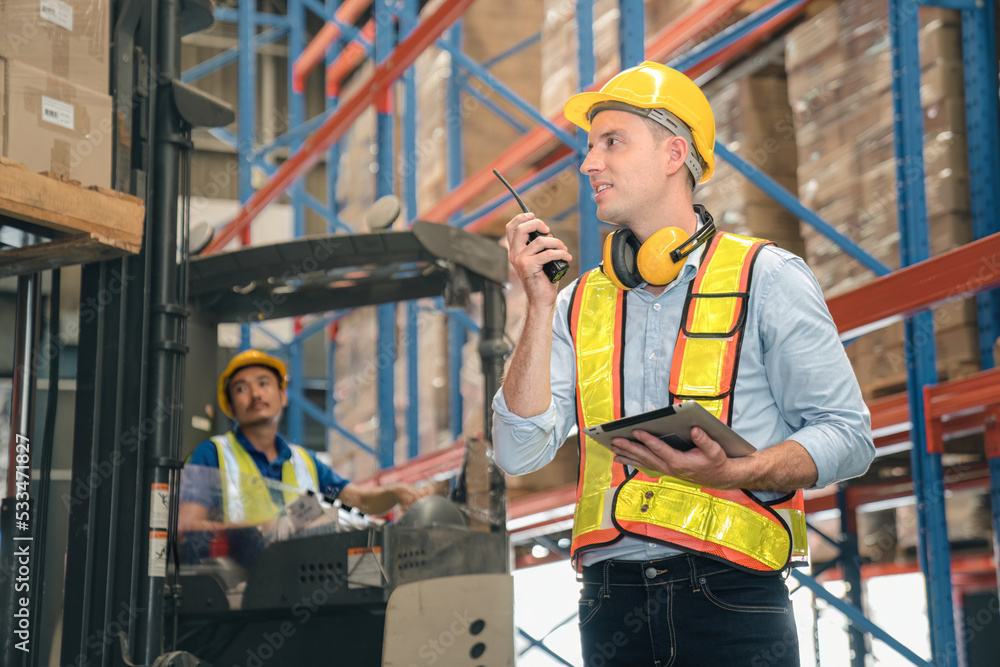 Smart caucasian warehouse man,manager use digital tablet check package with worker forklift driver loading box on shelf, product distribution inventory management, Logistics shipping business planning Smart caucasian warehouse man,manager use digital tablet check package with worker forklift driver loading box on shelf, product distribution inventory management, Logistics shipping business planning