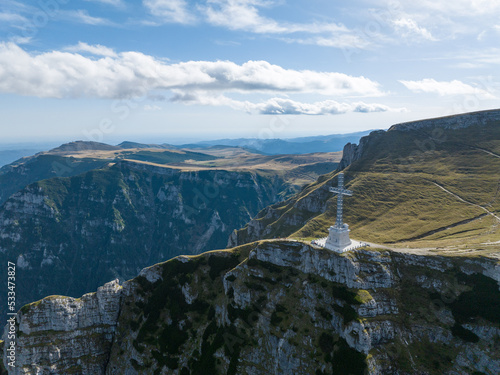 View of the Cross of Heroes on Mount Caraiman in the Bucegi Mountains, Romania photo