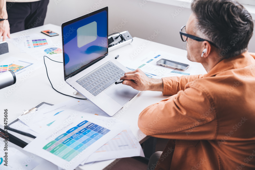 Concentrated man working on laptop in office Concentrated man working on laptop in office