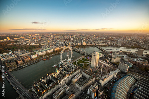 aerial view of the city of london and the river thames, with the millennium wheel in the foreground