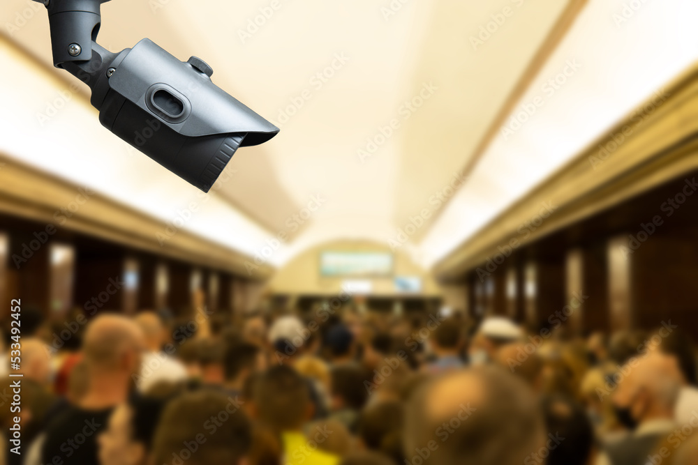 Obraz premium CCTV, security camera system operating with people waiting subway at train station, surveillance security and safety technology concept.