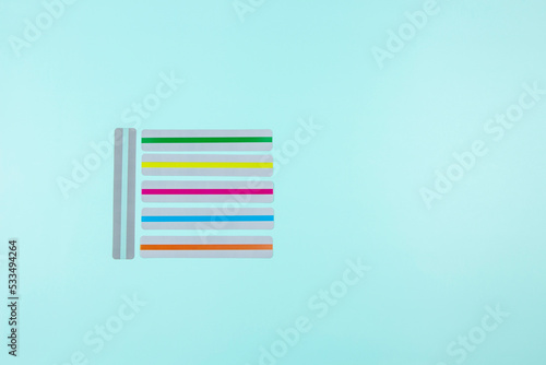 Dyslexia. Top view to colorful reading highlight bookmark overlay strips on light blue background. Reading rulers overlays, tools to help reading for people with dyslexia.